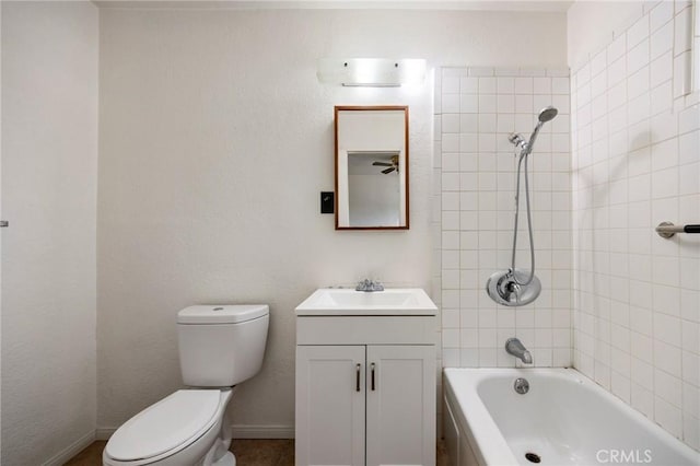 bathroom with washtub / shower combination, vanity, toilet, and baseboards