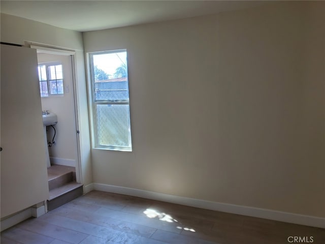 interior space with light wood-style floors and baseboards