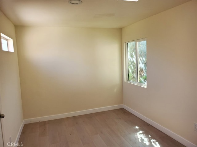 unfurnished room featuring light wood-style flooring and baseboards