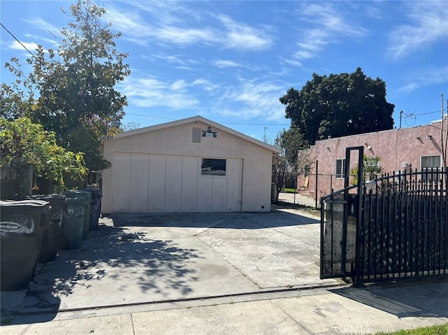 detached garage featuring fence