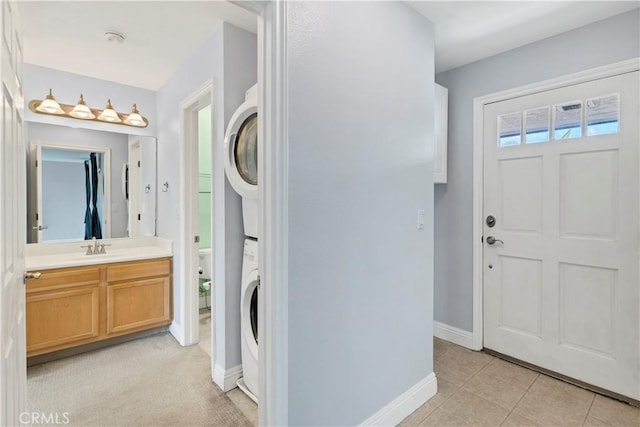 3535 Madison Ave, Unit San Diego, CA 92116 - washroom featuring stacked washing machine and dryer, baseboards, and light tile patterned floors