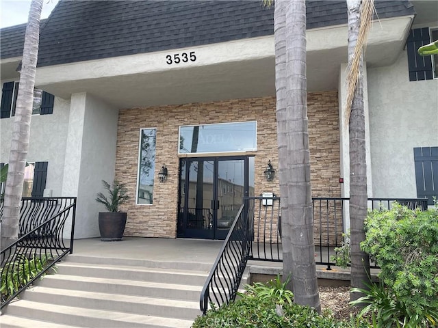 3535 Madison Ave, Unit San Diego, CA 92116 - entrance to property with stucco siding, roof with shingles, and covered porch
