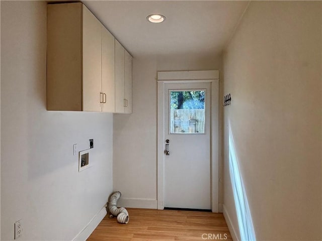 laundry area featuring light wood-style flooring, washer hookup, baseboards, cabinet space, and electric dryer hookup