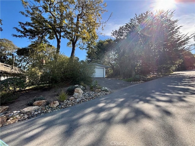 view of property exterior with a garage and an outbuilding