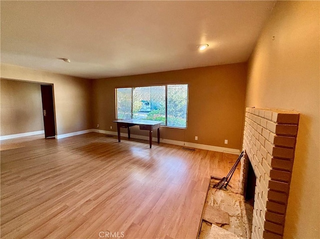 spare room with light wood-style floors and baseboards