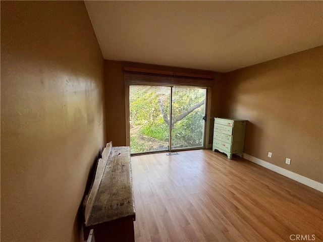 empty room featuring baseboards and wood finished floors