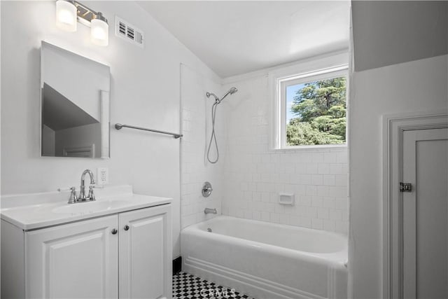 bathroom featuring visible vents, tub / shower combination, and vanity