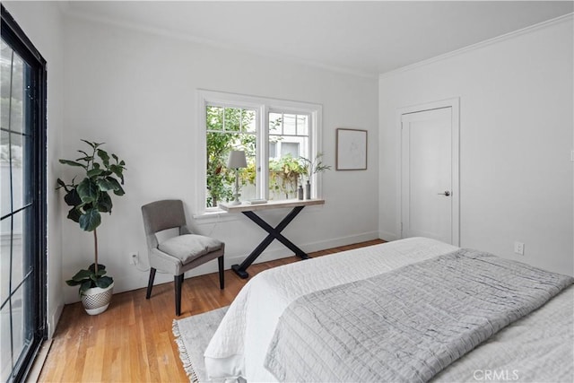 bedroom featuring crown molding and wood finished floors