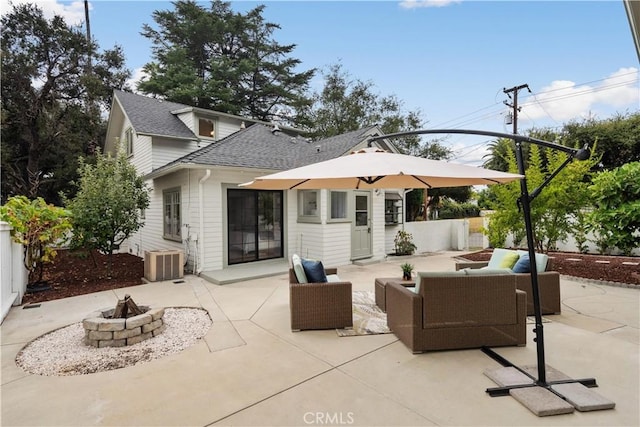 rear view of house featuring an outdoor living space with a fire pit, roof with shingles, fence, cooling unit, and a patio area