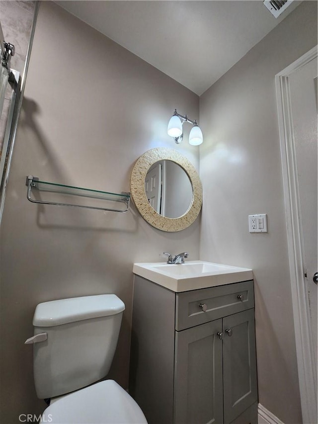 half bathroom featuring toilet and vanity