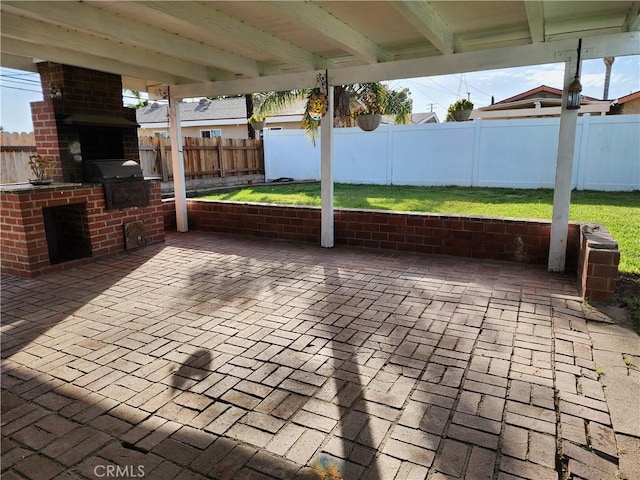 view of patio with a grill, an outdoor kitchen, and a fenced backyard