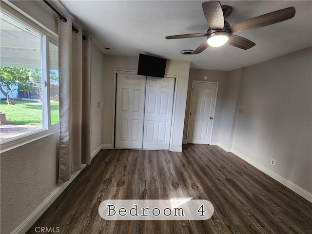 unfurnished bedroom featuring wood finished floors, visible vents, and baseboards