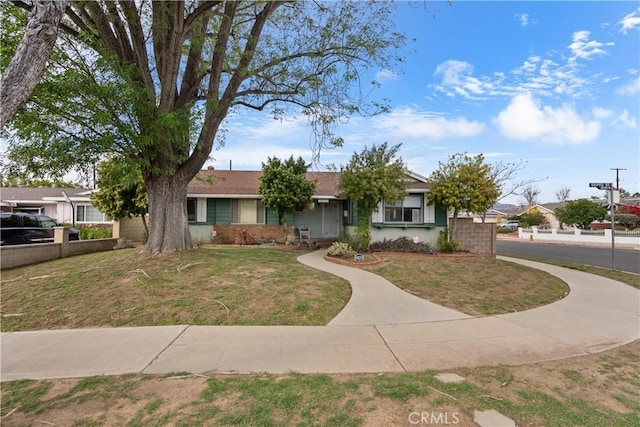 view of front of house with a front lawn and fence