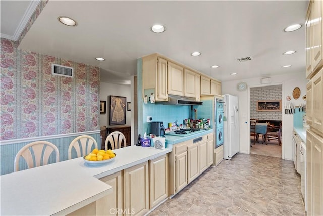 kitchen featuring under cabinet range hood, visible vents, light countertops, and recessed lighting