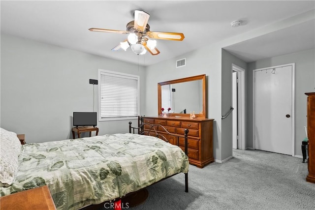 bedroom featuring ceiling fan, baseboards, visible vents, and light colored carpet