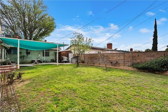 view of yard with fence and a patio