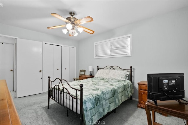 bedroom with a closet, a ceiling fan, and light colored carpet