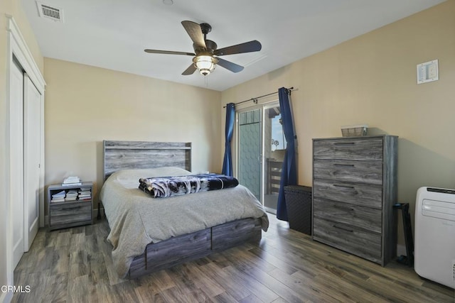 bedroom with visible vents, wood finished floors, a closet, a ceiling fan, and access to outside