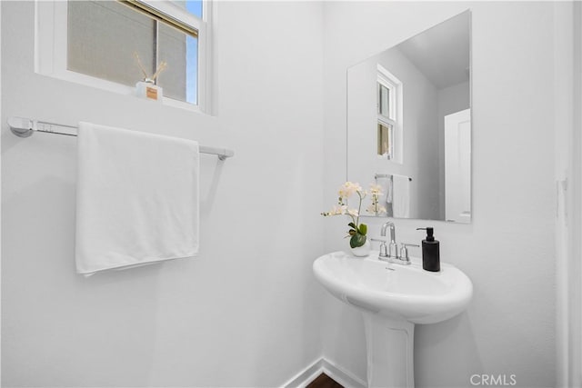 bathroom featuring a sink and baseboards