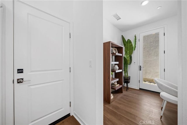 entryway with recessed lighting, visible vents, dark wood finished floors, and baseboards