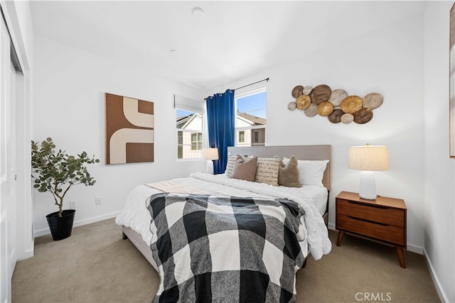 carpeted bedroom with baseboards