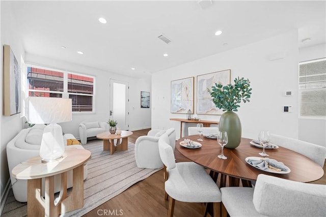 dining space featuring recessed lighting, visible vents, and wood finished floors