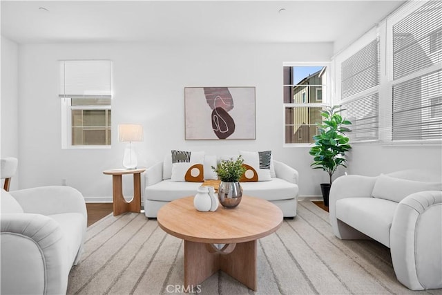 living area featuring light wood-style floors and baseboards