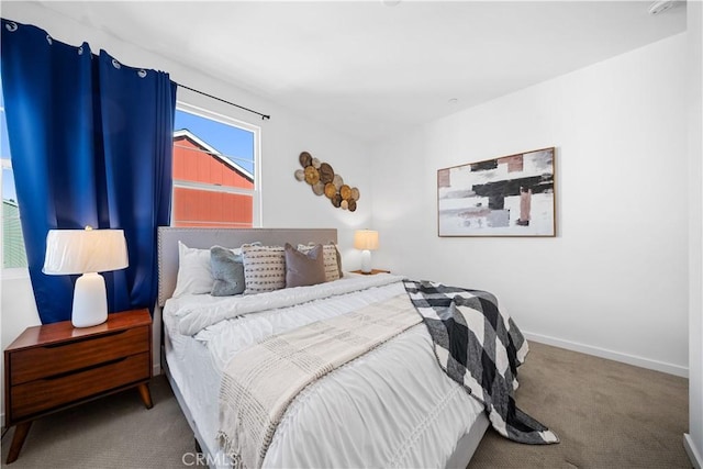 bedroom featuring carpet floors and baseboards