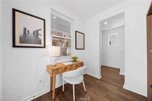 hall with baseboards and wood finished floors