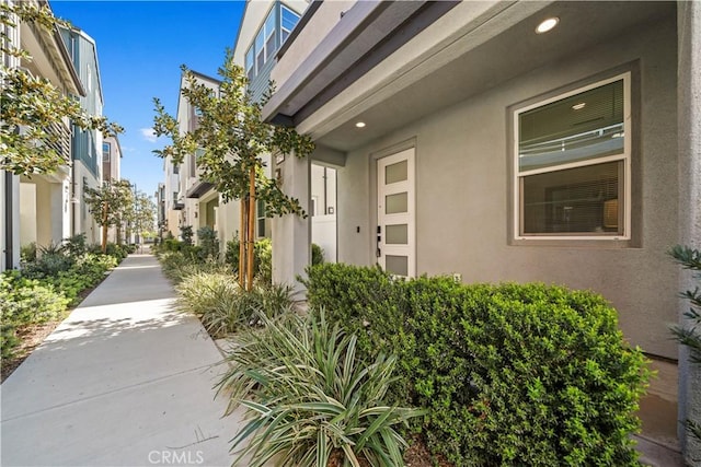 entrance to property featuring stucco siding