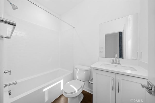 full bath featuring wood finished floors, bathing tub / shower combination, vanity, and toilet