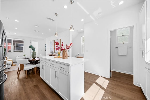 kitchen with dark wood-style flooring, recessed lighting, visible vents, and white cabinets