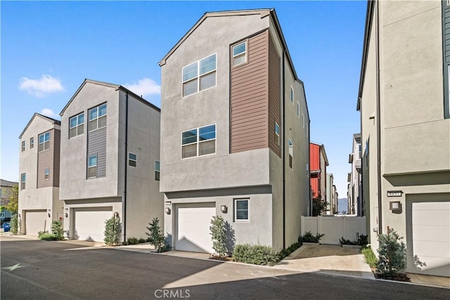 view of front facade with an attached garage and stucco siding