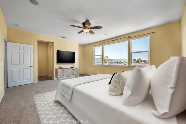 bedroom featuring carpet floors, a ceiling fan, visible vents, and baseboards