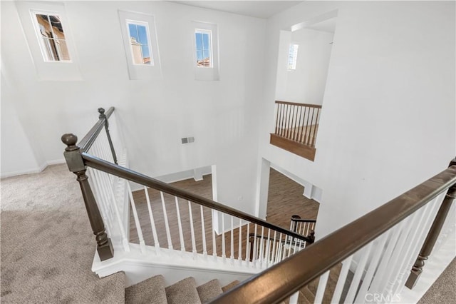 stairs featuring carpet and baseboards