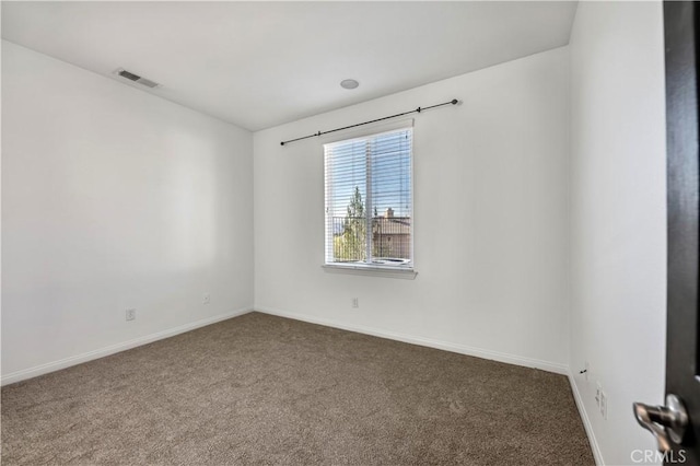 carpeted spare room with baseboards and visible vents