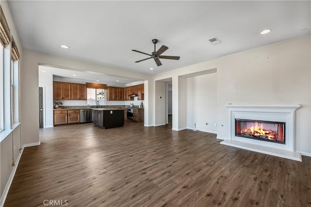 unfurnished living room with ceiling fan, dark wood finished floors, visible vents, and recessed lighting