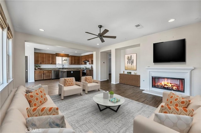 living room featuring wood finished floors, visible vents, and recessed lighting