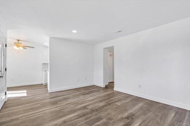 spare room featuring recessed lighting, wood finished floors, a ceiling fan, visible vents, and baseboards