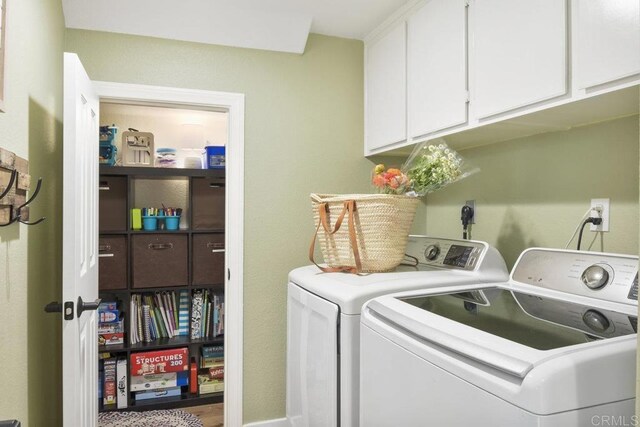 laundry room featuring cabinet space and separate washer and dryer