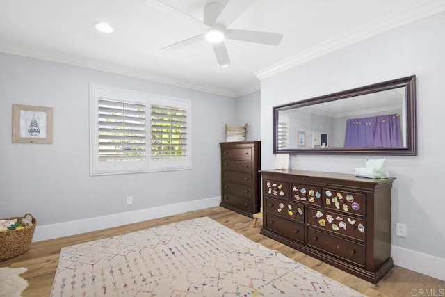 bedroom with a ceiling fan, wood finished floors, baseboards, and ornamental molding