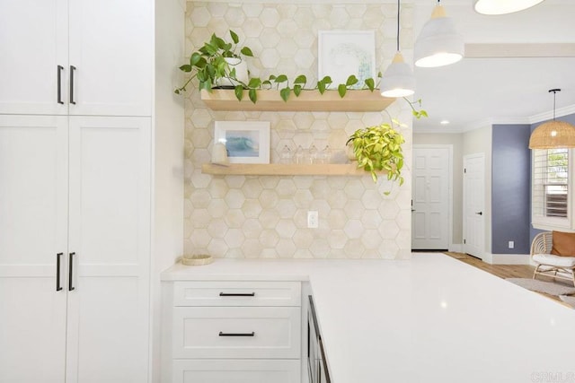 kitchen with white cabinetry, open shelves, crown molding, and light countertops