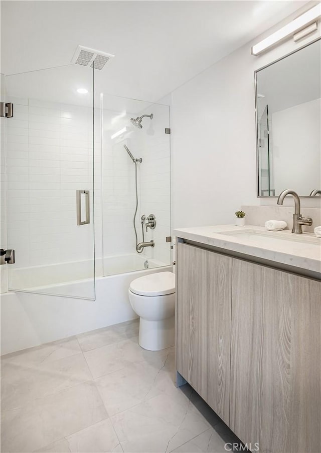 bathroom featuring toilet, vanity, shower / tub combination, and visible vents