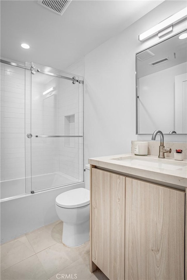 full bathroom featuring toilet, tile patterned floors, visible vents, and vanity