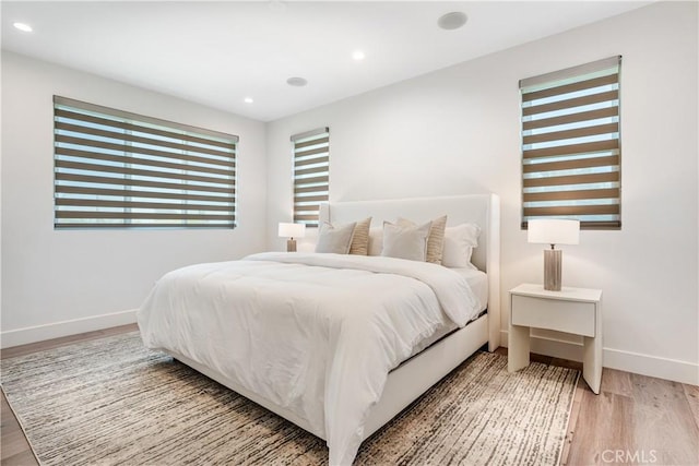 bedroom featuring recessed lighting, wood finished floors, and baseboards