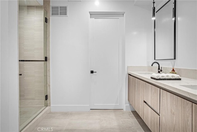 full bathroom featuring a stall shower, visible vents, a sink, and double vanity