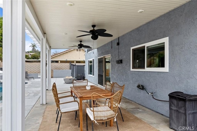 view of patio / terrace featuring ceiling fan, outdoor dining space, and fence