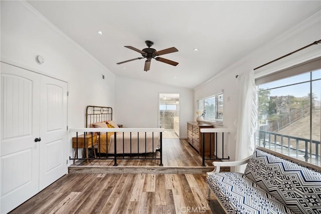 bedroom featuring connected bathroom, ornamental molding, wood finished floors, access to exterior, and vaulted ceiling