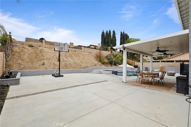 view of patio with outdoor dining area, a fenced backyard, a ceiling fan, and a fenced in pool