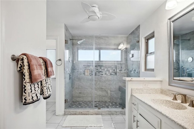 bathroom with ceiling fan, a stall shower, and vanity